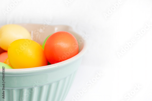 Easter basket filled with hand painted pastel Easter Eggs over a white background
