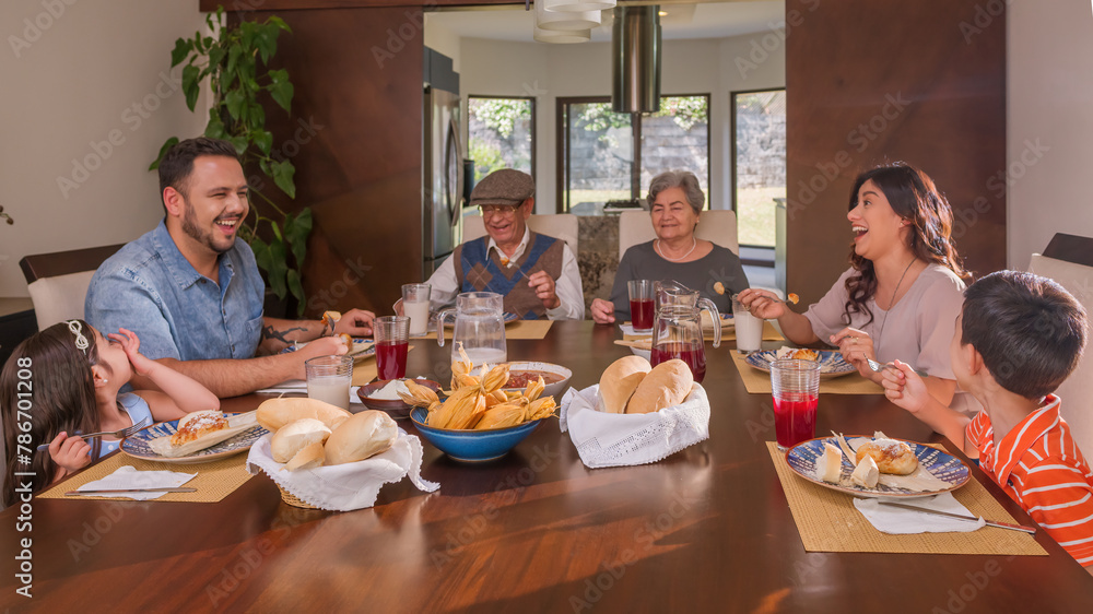 Latin family different generations enjoy thanksgiving food.