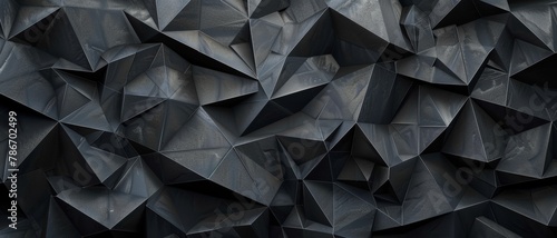 Abstract triangular mosaic tiles in dark black and anthracite gray concrete. Geometric fluted triangles create a textured wallpaper backdrop.