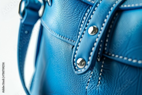A blue purse with white stitching and a silver clasp. Business fashion concept photo