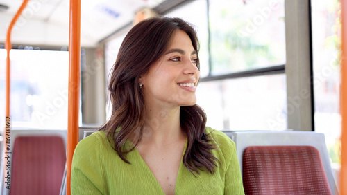 Portrait of a beautiful  young Latin woman riding in a city bus