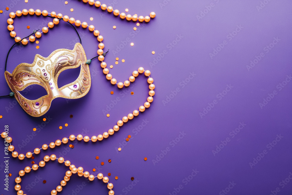 Mardi Gras carnival mask and beads on purple background Mardi Gras carnival mask and beads on purple background