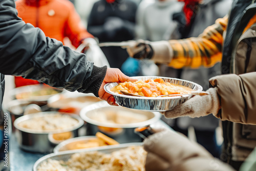 Volunteer hand serving meal to homeless people in shelter. Charity, donation, food distribution to poor people, food aid, food bank