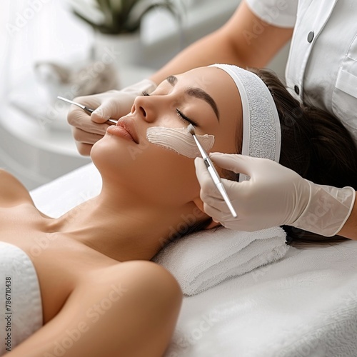 Young woman undergoing a dermaplaning facial treatment at a beauty center, focusing on skincare and wellness