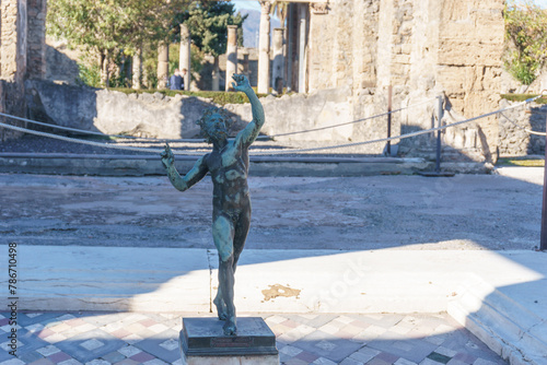 House of the Faun or Casa del Fauno with bronze statue at the ruins of Pompeii, Campania, Italy