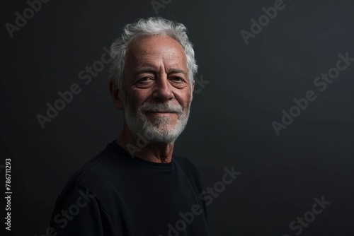 Portrait of a senior man with grey hair against a dark background