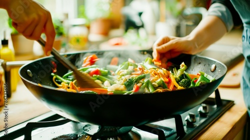 In a well-lit kitchen, a woman's hands confidently prepare a colorful vegetarian stir fry, a dance of flavors in a wok.