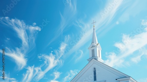 White church steeple against blue sky with wispy clouds photo