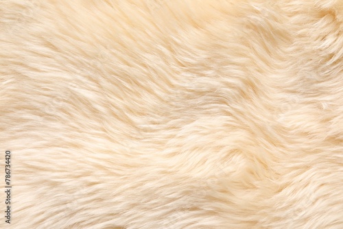 Texture of beige faux fur as background, top view