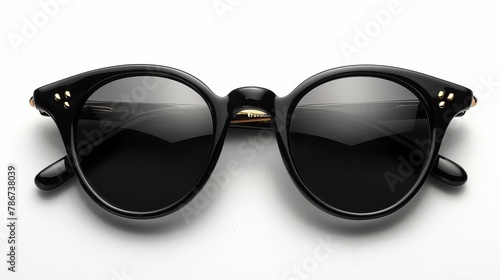 Stylish black sunglasses are isolated on a white background, viewed from the top.