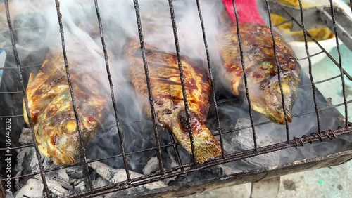 closeup of grilled fish on the charcoal grill