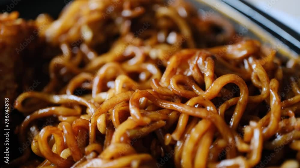 noodles with soy sauce and chicken in macro shot noodles with soy sauce and chicken in macro shot