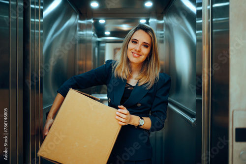 Happy Businesswoman Carrying a Delivery Box to her Office. Cheerful office worker resigning taking all her stuff   © nicoletaionescu