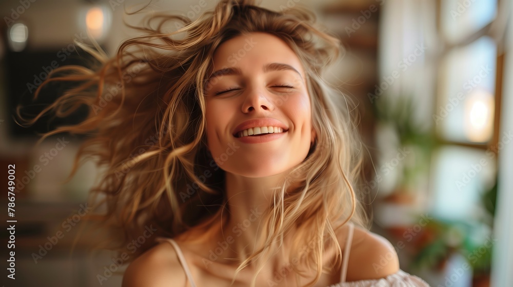 Fototapeta premium happy woman is dancing with her eyes closed and her hair is blowing in the wind