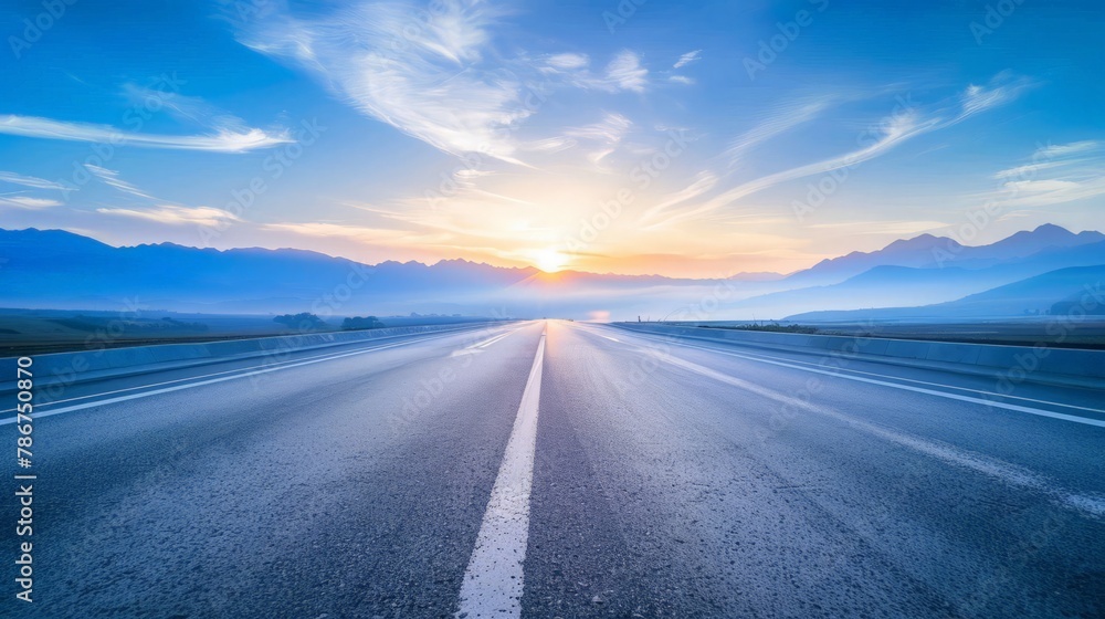 Empty asphalt road and mountain scenery at sunrise