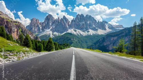 Road in mountains at sunny day in summer. Dolomites, Italy. Beautiful roadway, green tress, high rocks, blue sky with clouds.