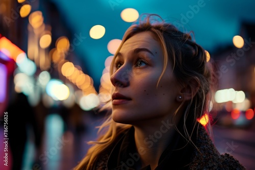 Portrait of a beautiful young woman in the city at night.