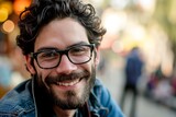 Portrait of handsome bearded man with eyeglasses in the city