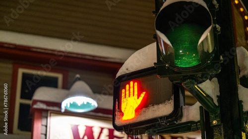 Close up of a traffic light at night displaying red. Do not cross, wait for the green light concept.
