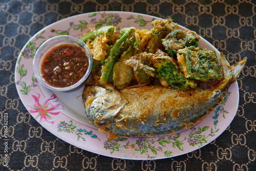 Fried mackerel fish with spicy shrimp paste and vegetable  on plate