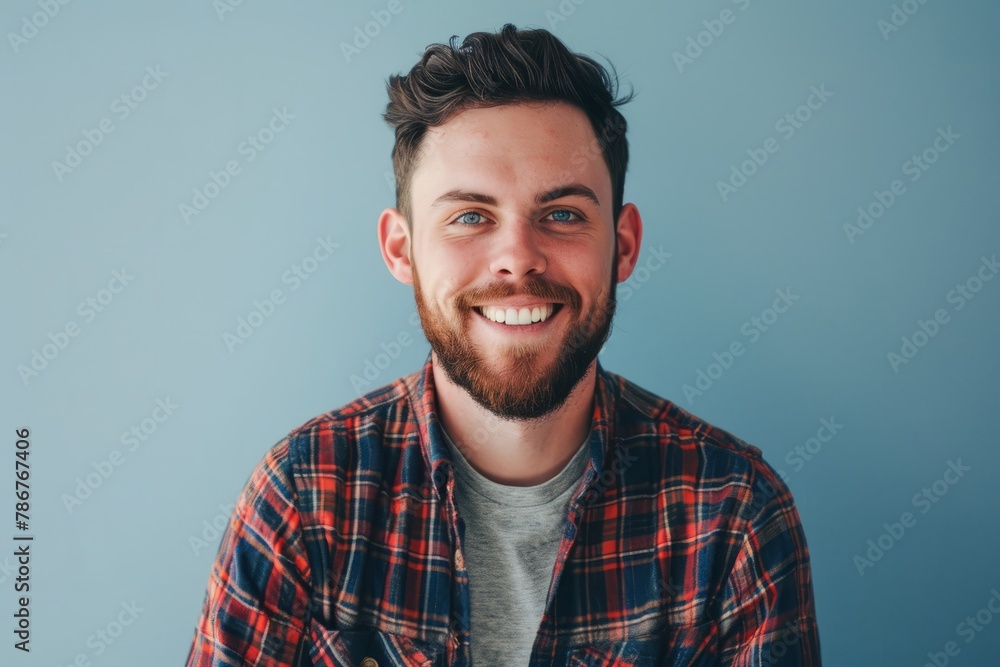 Portrait of a handsome bearded hipster man standing against grey background Portrait of a handsome bearded hipster man standing against grey background