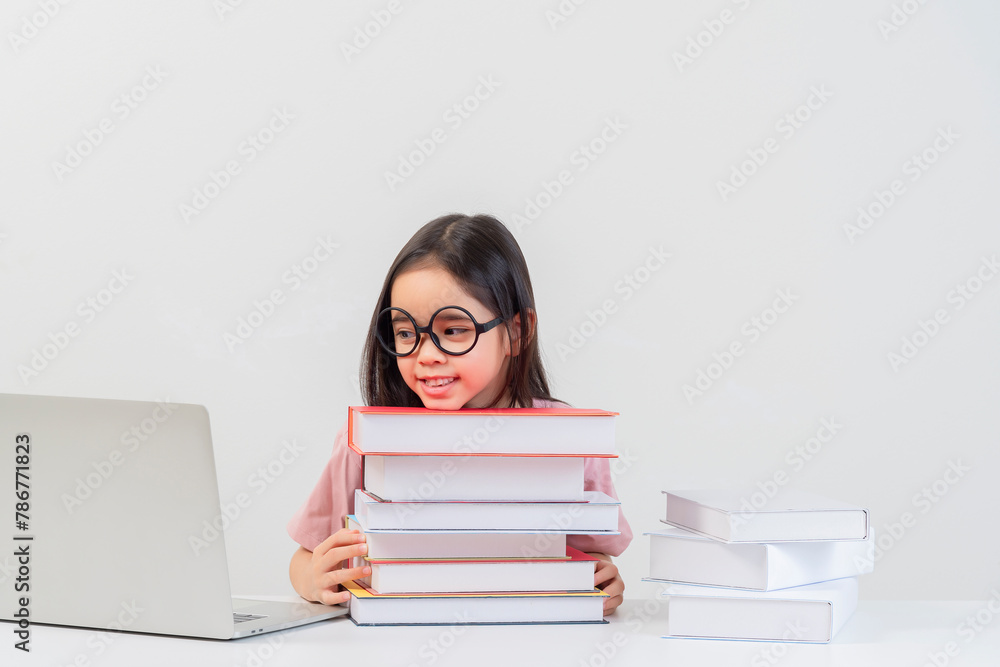 a student on the table and laptop among a large number of books a student on the table and laptop among a large number of books