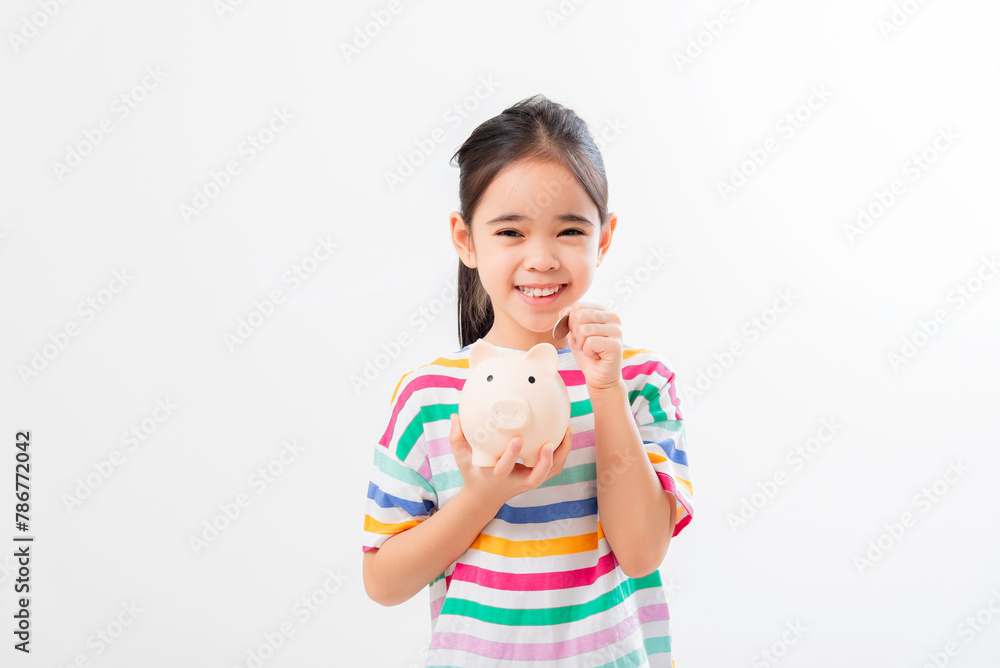 Little Asian girl saving money in a piggy bank, learning about saving, Little Asian girl saving money in a piggy bank, learning about saving,
