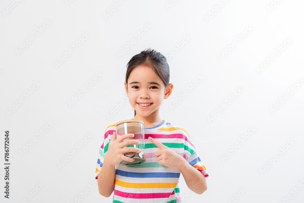 Little Asian girl saving money in a piggy bank, learning about saving, Little Asian girl saving money in a piggy bank, learning about saving,