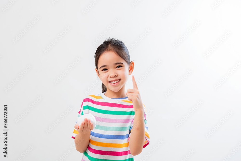 Cute Asian girl, holding foam, washing her face Cute Asian girl, holding foam, washing her face