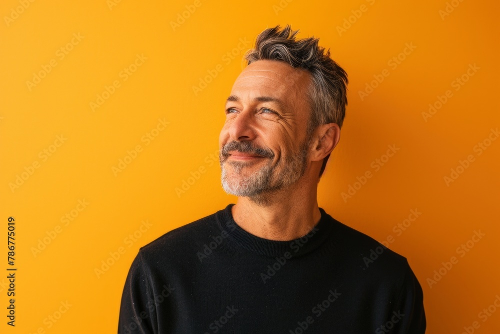 Portrait of a handsome middle-aged man on a yellow background Portrait of a handsome middle-aged man on a yellow background