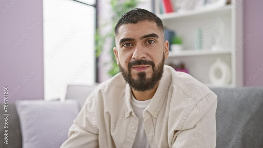 Bearded man smiling holding credit card indoors Bearded man smiling holding credit card indoors