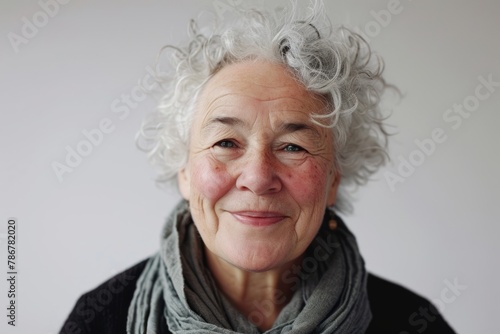 Portrait of a senior woman with grey hair and gray scarf. © Chacmool