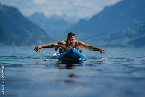 Tourist rest at the summer lake. Summer trip in nature. Peaceful water. Wellness spa concept in nature. Wild nature. Muscular Hispanic man posing. Seductive guy. Topless male model with a naked torso. photo