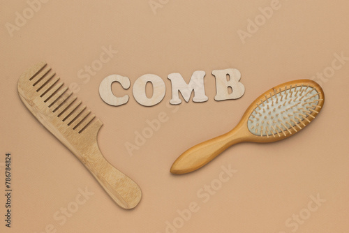 Two wooden combs and an inscription comb on a beige background.