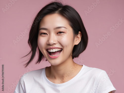 Radiant Laughter, Beautiful Young Asian Woman in Studio Lighting Against Pink Background © BNMK0819