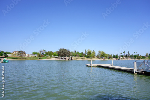 Double sided boat dock stretching into cool spring waters of Kiwanis park lake, Tempe, Arizona  © EuToch