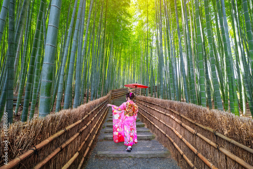 Bamboo forest. Japanese girl wearing a traditional Japanese kimono at the bamboo forest in Kyoto, Japan.
