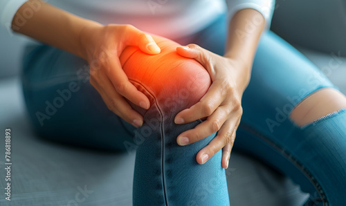 Woman Touching Painful Knee Suffering from Knee Pain photo