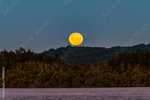 Full moon rising at the waterfront