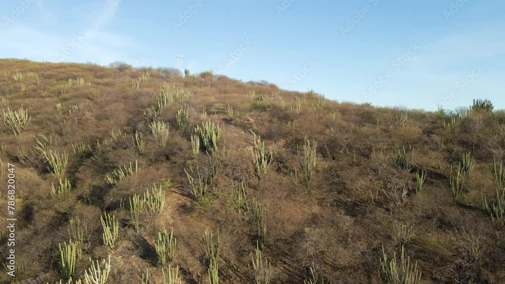 Drone skims across surface of arid coastal mountains to reveal cityscape of coastal Santa Marta, Colombia Drone skims across surface of arid coastal mountains to reveal cityscape of coastal Santa Marta, Colombia