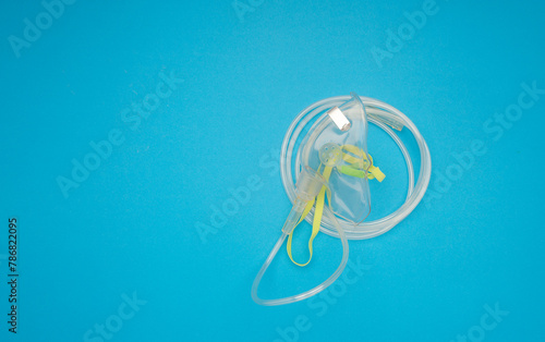 Top view of an oxygen mask on a blue background.