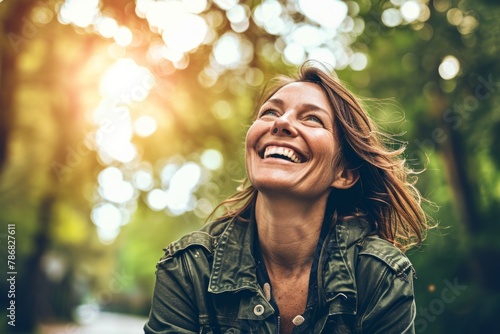 Close-up portrait of a happy young woman smiling at the camera outdoors