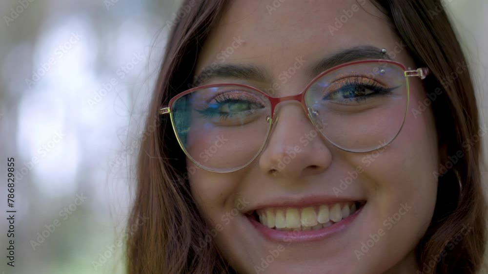 Ecuadorian woman with glasses smiles warmly in captivating close-up footage, exuding Latin charm. Ecuadorian woman with glasses smiles warmly in captivating close-up footage, exuding Latin charm.