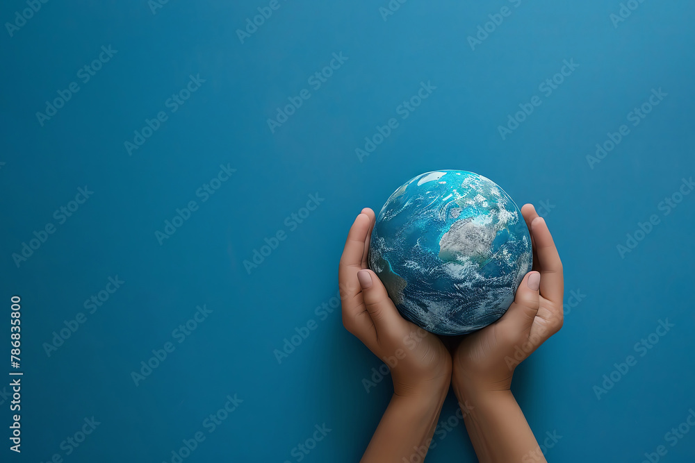 Silhouette of hands cradling a delicate paper Earth, solid blue background, space for text. Silhouette of hands cradling a delicate paper Earth, solid blue background, space for text.
