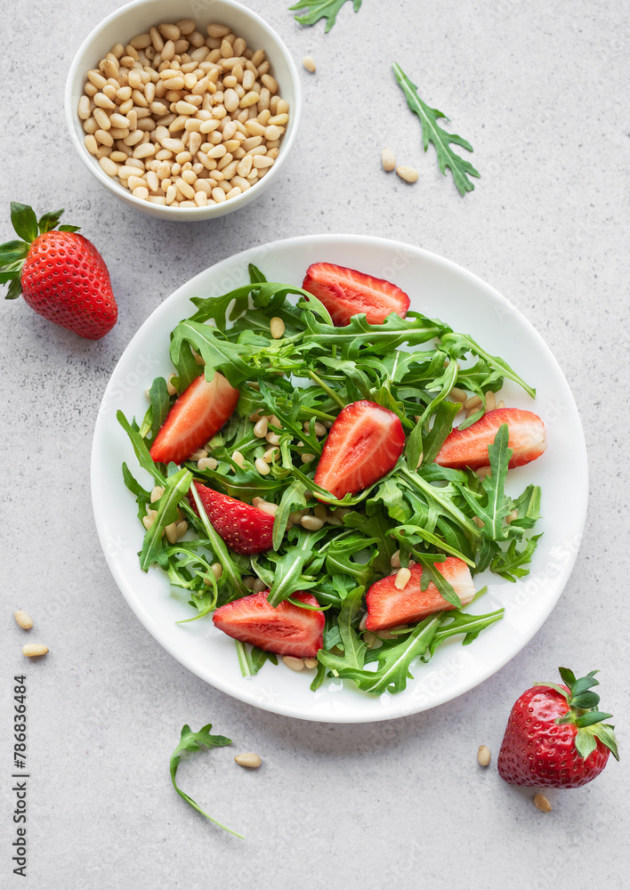 Fresh Strawberry Arugula Salad With Pine Nuts Served on a Bright Day