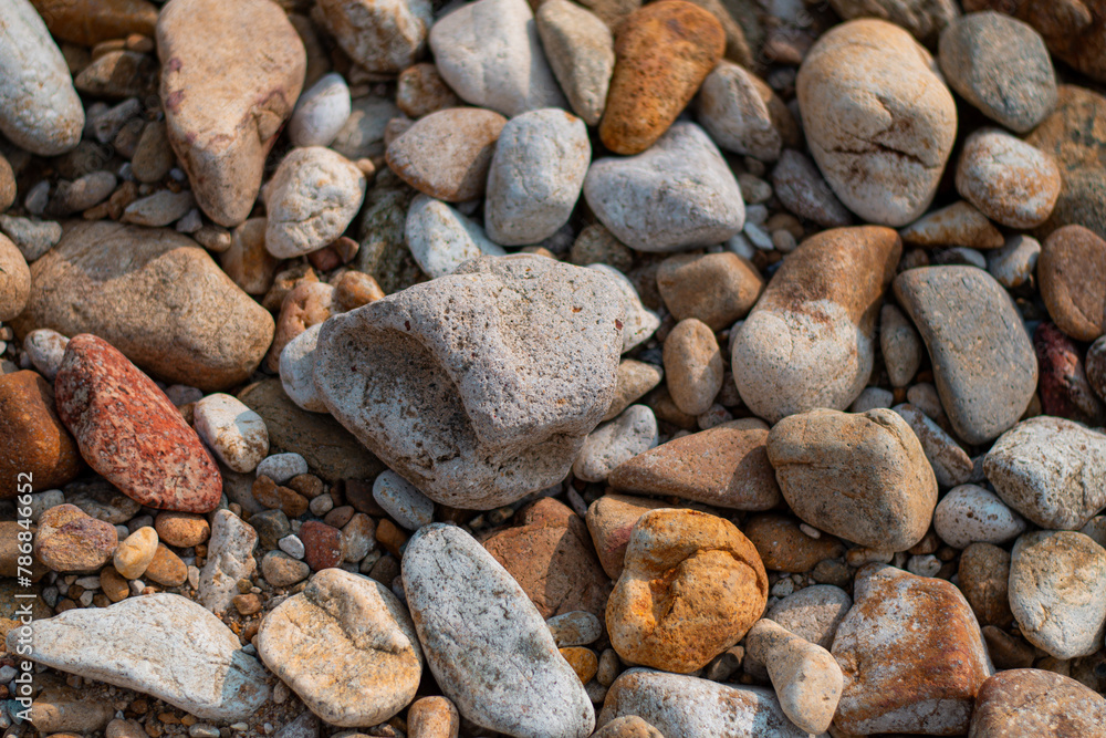 Gray sand and stones close-up on the beach. Stone in the foreground. Gray sand and stones close-up on the beach. Stone in the foreground.