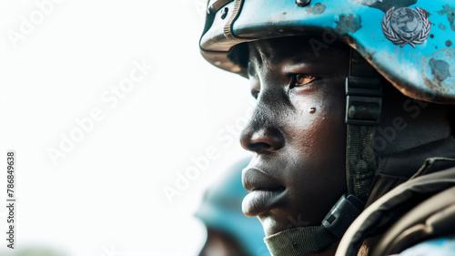 Close-up of a UN peacekeeper in helmet, focused and solemn expression, representing duty and service. photo