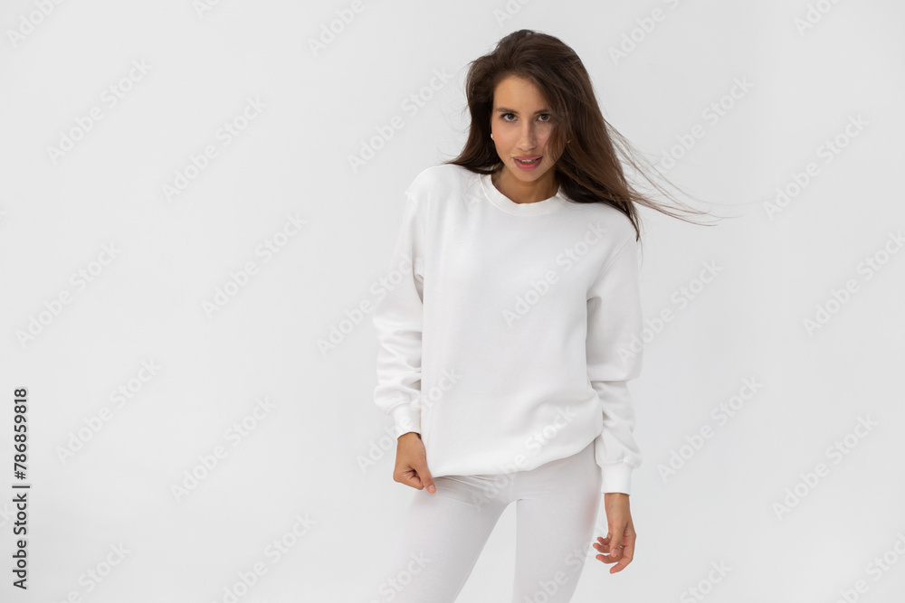 Beautiful brunette girl in a white sweatshirt and leggings Beautiful brunette girl in a white sweatshirt and leggings