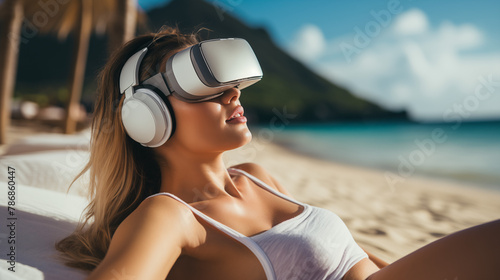 Woman relaxing at beach on her vacantion, enjoing sun and virtual reality photo