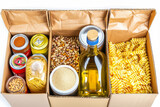 Foodstuff for donation isolated on white background with clipping path, storage and delivery. Various food, pasta, cooking oil and canned food in cardboard box . photo on white isolated background